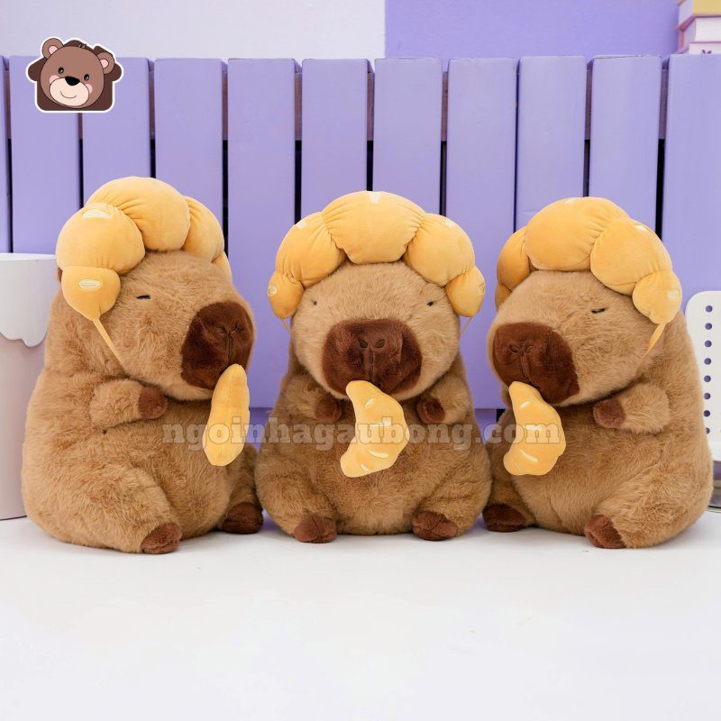 Gấu Bông Capybara Đội Bánh Sừng Bò