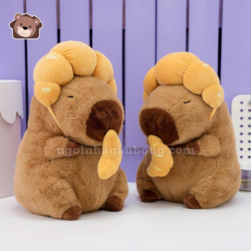 Gấu Bông Capybara Đội Bánh Sừng Bò