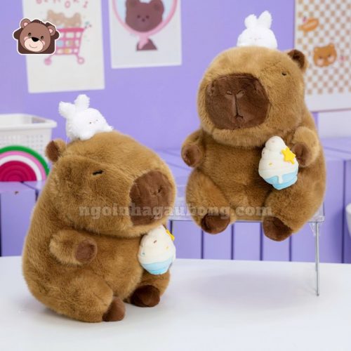 Gấu Bông Capybara Ôm Kem Đội Thỏ